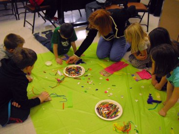 Janice helping students decorate their Puppets